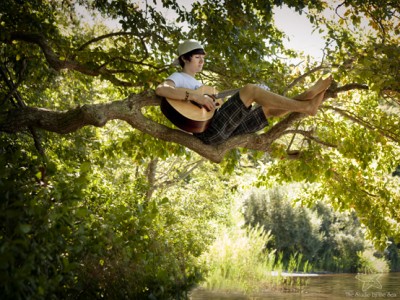 Senior in tree with guitar